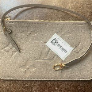 Louis Vuitton Never full mm wristlet Monogram Empreinte Leather In Turtle Dove.